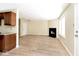 Open-concept living area with a black fireplace and light wood flooring at 4438 Fullwood Ct, Indianapolis, IN 46254