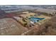 Aerial view of the property with a large pond, multiple buildings, open fields, and surrounding trees at 4981 E County Road 200 S, Avon, IN 46123