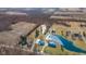 Aerial view of property highlighting large pond, house, and outbuildings with vast acreage at 4981 E County Road 200 S, Avon, IN 46123
