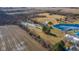 Expansive aerial view of property featuring a pond, barn, and fields at 4981 E County Road 200 S, Avon, IN 46123