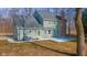 Back exterior view of a light green home with new patio and brick chimney at 4981 E County Road 200 S, Avon, IN 46123