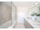 Bright bathroom with dual vanity sinks, a glass shower/tub, and modern fixtures at 4981 E County Road 200 S, Avon, IN 46123