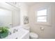 Clean bathroom with a white vanity, a framed mirror, and a window providing natural light at 4981 E County Road 200 S, Avon, IN 46123
