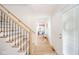 Bright foyer showcasing a staircase with iron spindles and a view into a comfortably furnished sitting room at 4981 E County Road 200 S, Avon, IN 46123