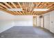 Large garage with open beams, fluorescent lighting, and large interior space with a roll-up door and service door at 4981 E County Road 200 S, Avon, IN 46123