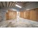 Partially finished garage space with plywood walls and visible studs, offering a customizable area for various purposes at 4981 E County Road 200 S, Avon, IN 46123