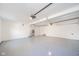 The spacious garage is finished with a clean, light gray painted floor and an updated garage door opener at 4981 E County Road 200 S, Avon, IN 46123