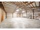 Spacious garage with open rafter ceiling, concrete floor, and ample storage space, perfect for various uses at 4981 E County Road 200 S, Avon, IN 46123