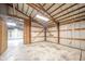 Rustic barn garage showcasing exposed beams and concrete flooring; ready for your vision at 4981 E County Road 200 S, Avon, IN 46123