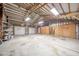 This barn garage boasts concrete floors and exposed wooden beams, offering a rustic and spacious area at 4981 E County Road 200 S, Avon, IN 46123