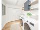 Bright laundry room with updated appliances, custom cabinets, and floating shelving at 4981 E County Road 200 S, Avon, IN 46123