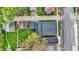 Aerial view of a residential neighborhood showcases a charming home, green lawns, and tree-lined streets at 5053 E Michigan St, Indianapolis, IN 46201