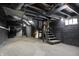 A dark basement reveals its utilities and exposed ductwork at 5053 E Michigan St, Indianapolis, IN 46201
