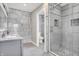 Elegant bathroom with a double sink, and a stand up shower with gray tile throughout at 5053 E Michigan St, Indianapolis, IN 46201