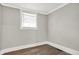 Bedroom features hardwood floors, neutral paint and a large window at 5053 E Michigan St, Indianapolis, IN 46201