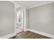 Bedroom features hardwood floors, neutral paint and view to the doorway at 5053 E Michigan St, Indianapolis, IN 46201