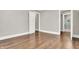 Bright bedroom featuring an en suite bath, fresh paint, hardwood floors, and crisp white trim at 5053 E Michigan St, Indianapolis, IN 46201