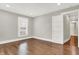 This bedroom has hardwood floors and a window that provides natural light at 5053 E Michigan St, Indianapolis, IN 46201