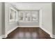 Bright bedroom features hardwood floors, multiple windows for natural light, and fresh trim and paint at 5053 E Michigan St, Indianapolis, IN 46201