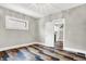Bedroom features hardwood floors, neutral paint and view to the staircase at 5053 E Michigan St, Indianapolis, IN 46201
