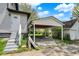 Open carport adjacent to a house with stairs and ample space for parking at 5053 E Michigan St, Indianapolis, IN 46201