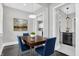 Dining room with hardwood floors, modern lighting, and view into the kitchen at 5053 E Michigan St, Indianapolis, IN 46201