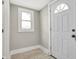 Entryway with tile floor, door and window with white trim at 5053 E Michigan St, Indianapolis, IN 46201
