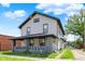 Charming two-story home with a covered porch and freshly painted siding at 5053 E Michigan St, Indianapolis, IN 46201