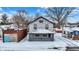 Charming two-story home with a cozy front porch and snow-covered yard at 5053 E Michigan St, Indianapolis, IN 46201