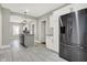 Modern kitchen boasts stainless steel refrigerator, island with granite countertops and tile flooring at 5053 E Michigan St, Indianapolis, IN 46201