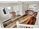 Open-concept living area with hardwood floors, stairs, and updated lighting fixtures at 5053 E Michigan St, Indianapolis, IN 46201