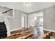 A large, light-filled living room featuring hardwood floors and access to additional rooms at 5053 E Michigan St, Indianapolis, IN 46201