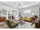 Staged living room with a view of the staircase, accented by stylish decor and natural light at 5053 E Michigan St, Indianapolis, IN 46201