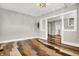 Bright living room featuring stylish multi-shade wood floors and a modern light fixture at 5053 E Michigan St, Indianapolis, IN 46201