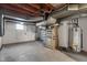 Unfinished basement with white painted walls, concrete floor and open ducts and systems at 5124 Wexford Rd, Indianapolis, IN 46226