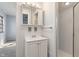 A bright bathroom includes a vanity with a sink and a shower at 5124 Wexford Rd, Indianapolis, IN 46226