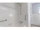 A tiled bathroom featuring a shower and safety grab bars at 5124 Wexford Rd, Indianapolis, IN 46226