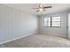 A carpeted bedroom features a ceiling fan and natural lighting from the window at 5124 Wexford Rd, Indianapolis, IN 46226