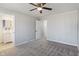 A carpeted bedroom features a ceiling fan and multiple doorways at 5124 Wexford Rd, Indianapolis, IN 46226