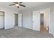A carpeted bedroom featuring multiple closets and an adjoining bathroom at 5124 Wexford Rd, Indianapolis, IN 46226