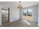 Bright dining room features updated flooring, elegant lighting, and a large window at 5124 Wexford Rd, Indianapolis, IN 46226