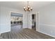 Well-lit dining room with modern flooring, leading to the living area and butler's pantry at 5124 Wexford Rd, Indianapolis, IN 46226