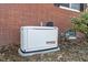 Exterior view of installed Generac generator on the side of a brick single Gathering home at 5124 Wexford Rd, Indianapolis, IN 46226