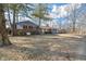 Single-Gathering home featuring a combination of brick and gray siding, surrounded by mature trees on a spacious lot at 5124 Wexford Rd, Indianapolis, IN 46226