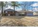 Quaint single-Gathering home with a brick and siding exterior, complemented by mature trees and a well-manicured lawn at 5124 Wexford Rd, Indianapolis, IN 46226