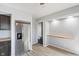 Well-lit kitchen with stainless steel refrigerator and floating shelves at 5124 Wexford Rd, Indianapolis, IN 46226