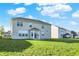Spacious backyard showcasing the home's exterior, with sliding glass doors and ample green space, ideal for Gathering gatherings at 5648 Juniper Ct, Whitestown, IN 46075