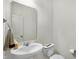 Bathroom with a pedestal sink, a mirror, and a toilet, all in a clean, modern design at 5648 Juniper Ct, Whitestown, IN 46075