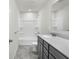 Bathroom features a shower-tub combo, vanity sink, and tiled floor at 5648 Juniper Ct, Whitestown, IN 46075