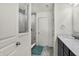 Modern bathroom featuring a tiled shower with glass door, dark vanity, and tiled floors at 5648 Juniper Ct, Whitestown, IN 46075